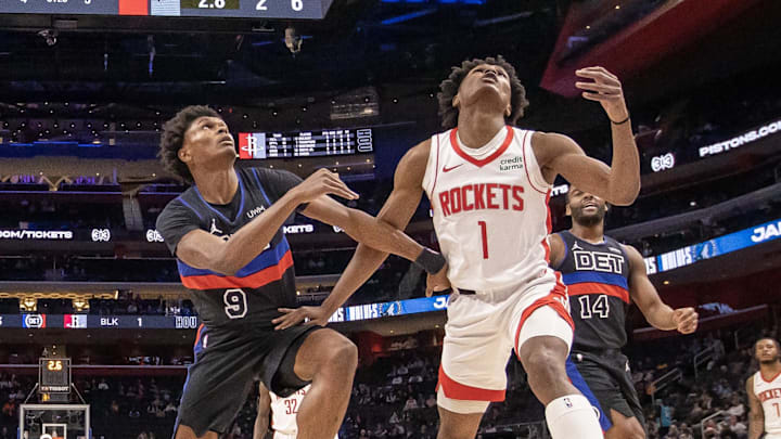 Jan 12, 2024; Detroit, Michigan, USA; Detroit Pistons forward Ausar Thompson (9) battles for for the ball with his twin brother Houston Rockets forward Amen Thompson (1) during the first half at Little Caesars Arena. Mandatory Credit: David Reginek-Imagn Images