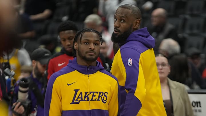 Los Angeles Lakers forward LeBron James looks back at guard Bronny James during warm-ups.