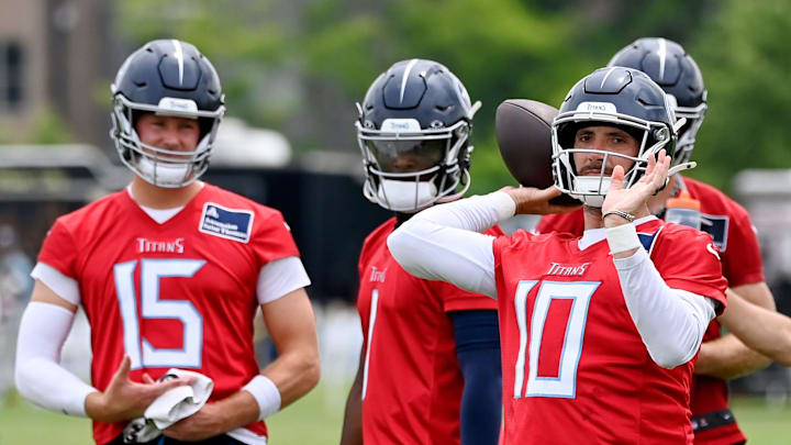 Tennessee Titans quarterback Brandon Allen passes as Tim Boyle and Cam Ward watch.