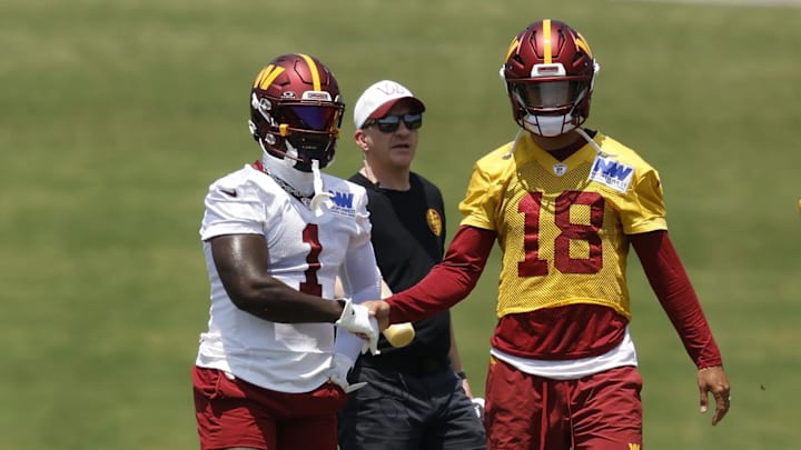 Jun 10, 2025; Ashburn, VA, USA; Washington Commanders wide receiver Deebo Samuel Sr. (1) shakes hands with Commanders quarterback Marcus Mariota (18) between drills on day one of minicamp at Commanders Park. Mandatory Credit: Geoff Burke-Imagn Images