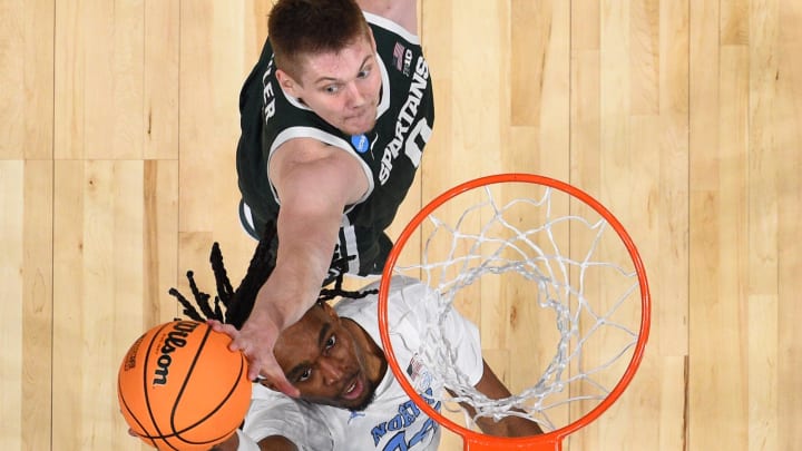 Mar 23, 2024; Charlotte, NC, USA; North Carolina Tar Heels forward Jae'Lyn Withers (24) has his shot blocked by Michigan State Spartans forward Jaxon Kohler (0) at Spectrum Center. Mandatory Credit: Bob Donnan-USA TODAY Sports