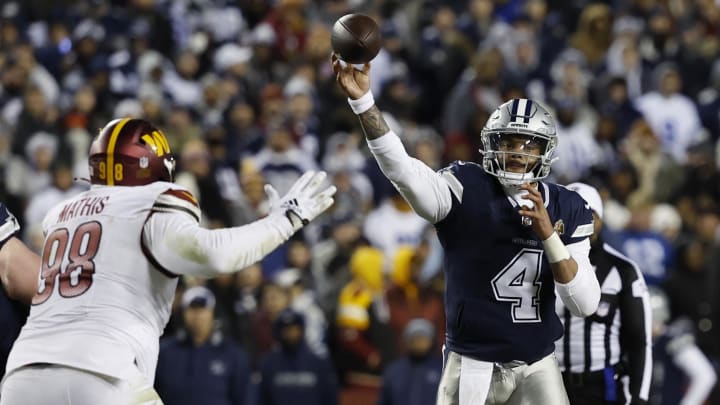 Jan 7, 2024; Landover, Maryland, USA; Dallas Cowboys quarterback Dak Prescott (4) passes the ball as Washington Commanders defensive tackle Phidarian Mathis (98) defends during the fourth quarter at FedExField. Mandatory Credit: Geoff Burke-USA TODAY Sports
