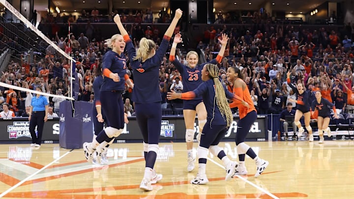 The Virginia volleyball team celebrates after scoring a point against Virginia Tech at John Paul Jones Arena.