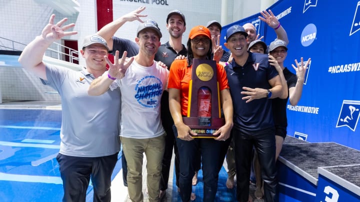 UVA athletics director Carla Williams and the Virginia swim & dive coaching staff pose with the 2024 NCAA Women's Swim & Dive National Championship trophy.