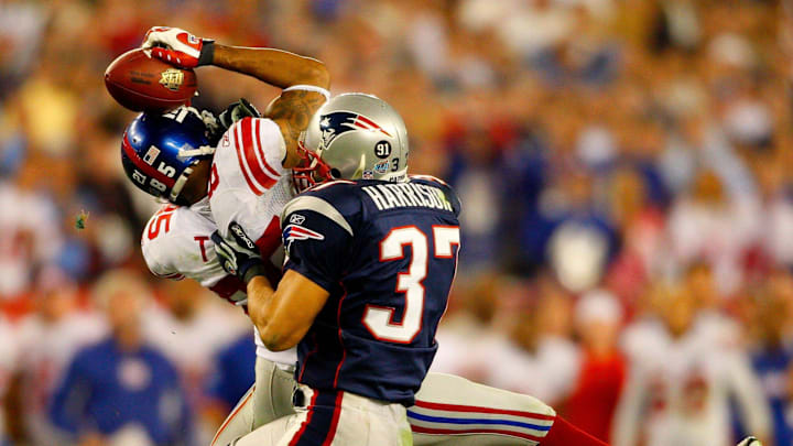 Giants receiver David Tyree catches a pass while in the clutches of Patriots safety Rodney Harrison en route to New York's 17-14 victory over New England in Super Bowl XLII.