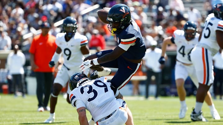 Suderian Harrison is tackled by Robbie Engelberg during the Virginia football spring game at Scott Stadium. Suderian Harrison is tackled by Robbie Engelberg during the Virginia football spring game at Scott Stadium.