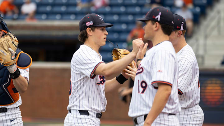 Bryson Moore greets his teammates after completing an inning during the Virginia baseball game against George Mason. Bryson Moore greets his teammates after completing an inning during the Virginia baseball game against George Mason.