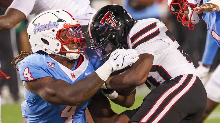 Oct 4, 2025; Houston, Texas, USA; Texas Tech Red Raiders running back J'Koby Williams (20) is tackled by Houston Cougars defensive end Brandon Mack (4) in the second half at TDECU Stadium. Mandatory Credit: Thomas Shea-Imagn Images Oct 4, 2025; Houston, Texas, USA; Texas Tech Red Raiders running back J'Koby Williams (20) is tackled by Houston Cougars defensive end Brandon Mack (4) in the second half at TDECU Stadium. Mandatory Credit: Thomas Shea-Imagn Images