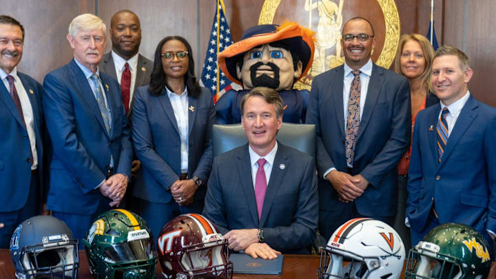 Virginia Governor Glenn Youngkin signs House Bill 1505 into law with UVA athletics director Carla Williams and head football coach Tony Elliott beside him. Virginia Governor Glenn Youngkin signs House Bill 1505 into law with UVA athletics director Carla Williams and head football coach Tony Elliott beside him.