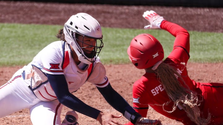 Texas Tech's Desirae Spearman scores a run around Arizona catcher Sydney Stewart during a Big 12 Conference softball game, Saturday, March 14, 2026, at Rocky Johnson Field. Texas Tech's Desirae Spearman scores a run around Arizona catcher Sydney Stewart during a Big 12 Conference softball game, Saturday, March 14, 2026, at Rocky Johnson Field.