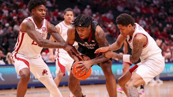 Texas Tech's JT Toppin is crowded by Arkansas defenders Nick Pringle (left) and Meleek Thomas during a non-conference men's basketball game, Saturday, Dec. 13, 2025, at American Airlines Center in Dallas. Texas Tech's JT Toppin is crowded by Arkansas defenders Nick Pringle (left) and Meleek Thomas during a non-conference men's basketball game, Saturday, Dec. 13, 2025, at American Airlines Center in Dallas.