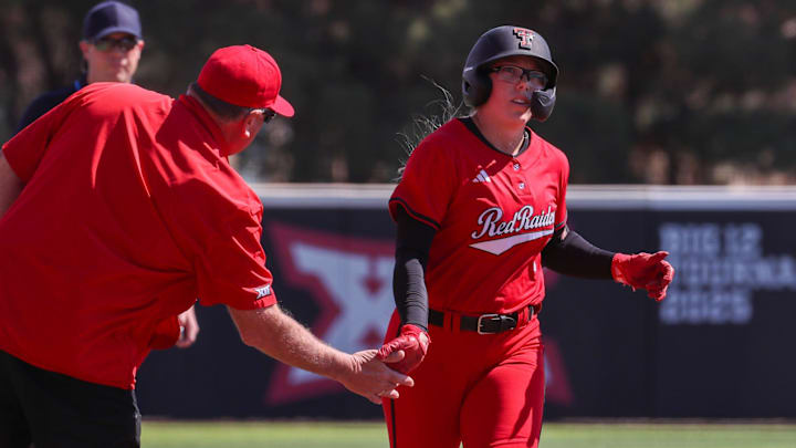 Texas Tech's Mia Williams high-fives Gerry Glasco after hitting a home rung against Texas A&M-Corpus Christi during a Division I non-conference softball game, Sunday, March 1, 2026, at Rocky Johnson Field.