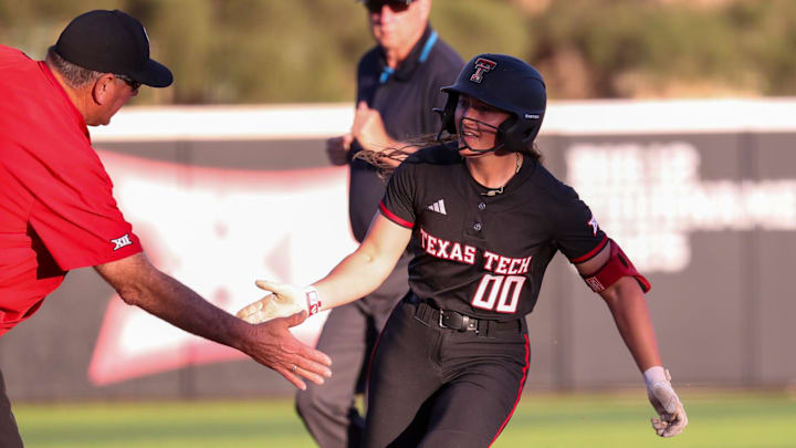 Texas Tech's Jackie Lis high-fives head coach Gerry Glasco after hitting a home run against North Texas during a Division I non-conference softball game, Friday, Feb. 27, 2026, at Rocky Johnson Field.