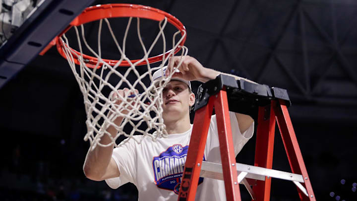 Feb 28, 2026; Gainesville, Florida, USA; Florida Gators forward Thomas Haugh (10) cuts down the net following a win over the Arkansas Razorbacks at Exactech Arena at the Stephen C. O'Connell Center. Mandatory Credit: Travis Register-Imagn Images