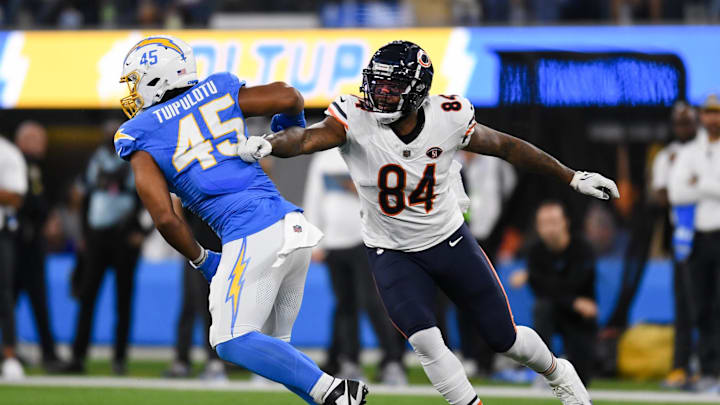 Oct 29, 2023; Inglewood, California, USA; Chicago Bears tight end Marcedes Lewis (84) attempts to block Los Angeles Chargers linebacker Tuli Tuipulotu (45) during second quarter at SoFi Stadium. Mandatory Credit: Jonathan Hui-Imagn Images