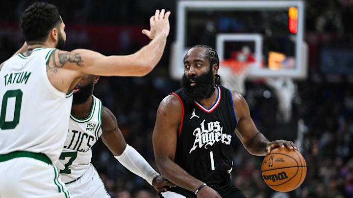 Dec 23, 2023; Los Angeles, California, USA; Los Angeles Clippers guard James Harden (1) looks to pass against Boston Celtics forward Jayson Tatum (0) and forward Jaylen Brown (7) during the third quarter at Crypto.com Arena. Mandatory Credit: Jonathan Hui-Imagn Images