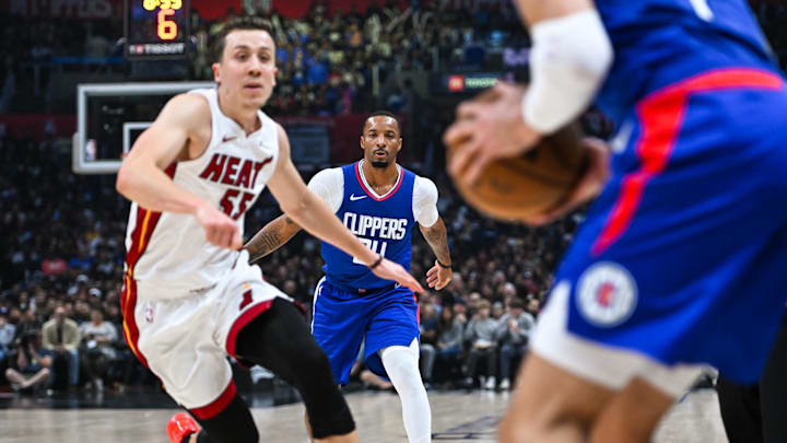 Jan 1, 2024; Los Angeles, California, USA; Miami Heat forward Duncan Robinson (55) looks to block against Los Angeles Clippers guard Amir Coffey (7) and Clippers guard Norman Powell (24) during the second quarter at Crypto.com Arena. Mandatory Credit: Jonathan Hui-Imagn Images