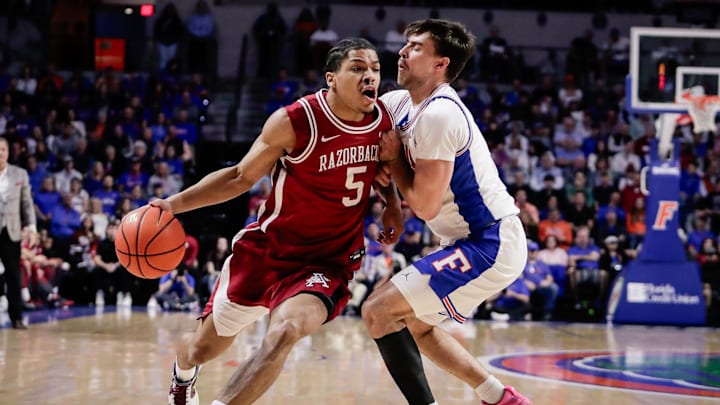 Feb 28, 2026; Gainesville, Florida, USA; Arkansas Razorbacks guard Darius Acuff Jr. (5) drives the ball against Florida Gators guard Urban Klavzar (7) during the first half at Exactech Arena at the Stephen C. O'Connell Center. Mandatory Credit: Travis Register-Imagn Images