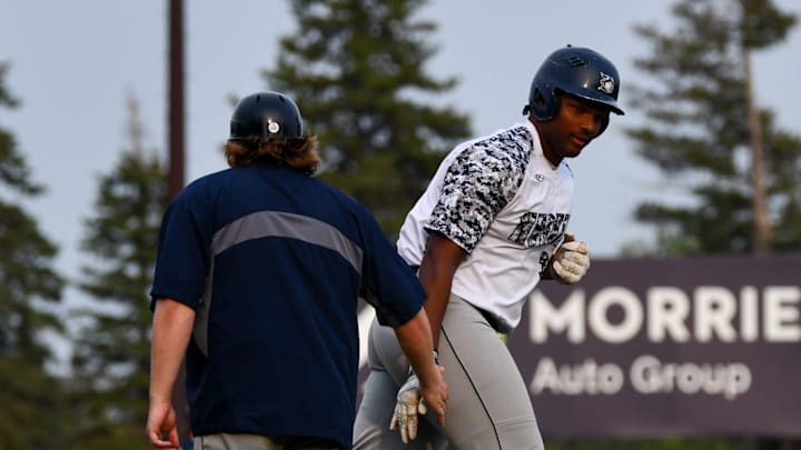 Duluth Husky Brylan West high-fives his third base coach after hitting a solo home run Tuesday against the St. Cloud Rox at Joe Faber Field. Duluth lost 9-1 as West had two of the Huskies' three hits. The sophomore at Florida International has hit two home runs this summer.