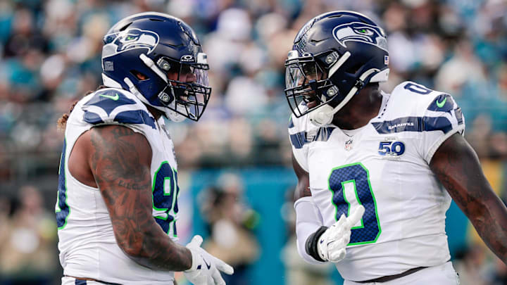 Oct 12, 2025; Jacksonville, Florida, USA;Seattle Seahawks defensive end Leonard Williams (99) and linebacker DeMarcus Lawrence (0) celebrate after a play against the Jacksonville Jaguars at EverBank Stadium. Mandatory Credit: Travis Register-Imagn Images