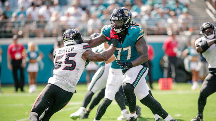 Sep 21, 2025; Jacksonville, Florida, USA; Jacksonville Jaguars offensive lineman Anton Harrison (77) blocks against the Houston Texans at EverBank Stadium. Mandatory Credit: Travis Register-Imagn Images