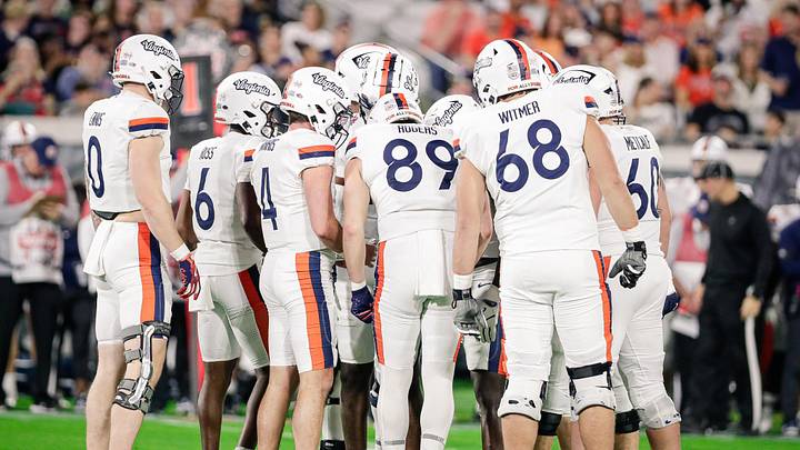 Dec 27, 2025; Jacksonville, FL, USA; Virginia Cavaliers offensive players huddle during the Gator Bowl against the Missouri Tigers in the first half at EverBank Stadium. Mandatory Credit: Travis Register-Imagn Images Dec 27, 2025; Jacksonville, FL, USA; Virginia Cavaliers offensive players huddle during the Gator Bowl against the Missouri Tigers in the first half at EverBank Stadium. Mandatory Credit: Travis Register-Imagn Images
