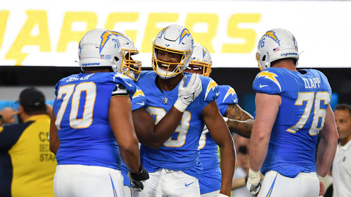 Oct 29, 2023; Inglewood, California, USA; Los Angeles Chargers tight end Donald Parham Jr. (89) celebrates with offensive tackle Rashawn Slater (70) and center Will Clapp (76) after scoring a touchdown against then Chicago Bears during second quarter at SoFi Stadium. Mandatory Credit: Jonathan Hui-Imagn Images
