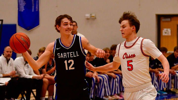Sartell boys basketball senior George Durrwachter makes a pass during a 2024 Granite City Classic game Dec. 27 at home versus Osseo. The Sabres won 60-55.