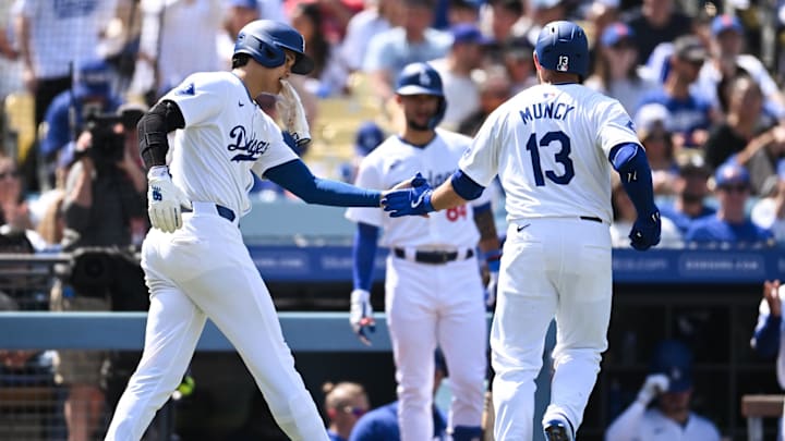 Apr 20, 2024; Los Angeles, California, USA; Los Angeles Dodgers designated hitter Shohei Ohtani (17) fives third baseman Max Muncy (13) after scoring against the New York Mets during the fifth inning at Dodger Stadium. Mandatory Credit: Jonathan Hui-Imagn Images
