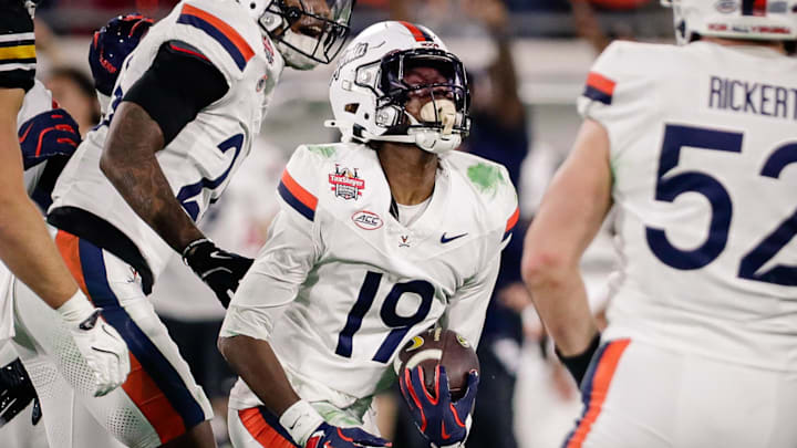 Virginia cornerback Emmanuel Karnley (19), considering a transfer to UW, celebrates an interception against Missouri. 