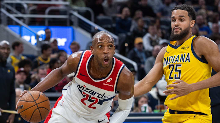 Nov 28, 2025; Indianapolis, Indiana, USA;  Washington Wizards forward Khris Middleton (22) dribbles the ball while  Indiana Pacers forward Jeremiah Robinson-Earl (25) defends in the second half at Gainbridge Fieldhouse. Mandatory Credit: Trevor Ruszkowski-Imagn Images