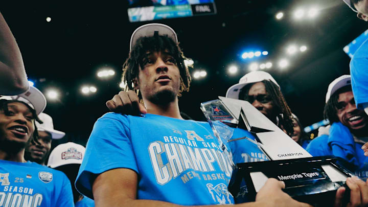 PJ Haggerty holds the AAC regular season champion trophy 