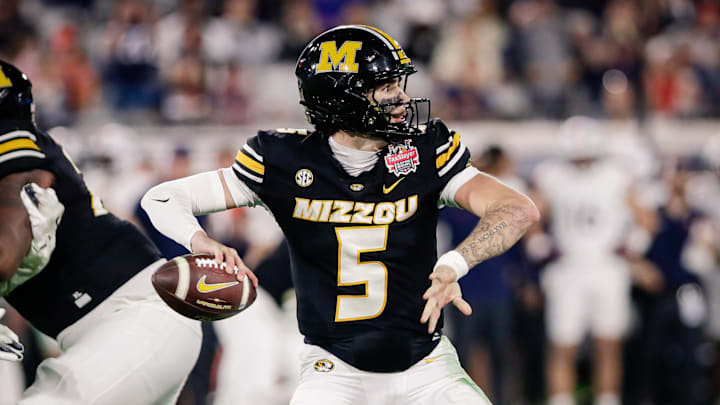 Dec 27, 2025; Jacksonville, FL, USA; Missouri Tigers quarterback Matt Zollers (5) throws a pass against the Virginia Cavaliers during the second quarter at EverBank Stadium. Mandatory Credit: Travis Register-Imagn Images