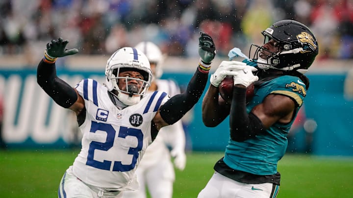 Dec 7, 2025; Jacksonville, Florida, USA;Jacksonville Jaguars wide receiver Brian Thomas Jr. (7) catches a pass over Indianapolis Colts cornerback Kenny Moore II (23) at EverBank Stadium. Mandatory Credit: Travis Register-Imagn Images
