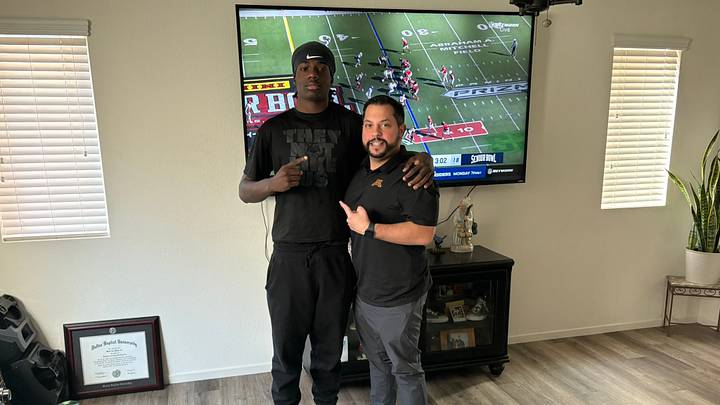 Maxwell Miles with Gophers defensive coordinator Danny Collins during an in-home visit. Maxwell Miles with Gophers defensive coordinator Danny Collins during an in-home visit.