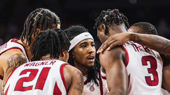 Boogie Fland (2) leads the huddle with Adou Thiero (3), Johnell Davis (1), DJ Wagner (21), Trevon Brazile (4) against the Troy Trojans. The Razorbacks won 65-49.