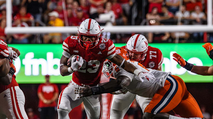Running back, Dante Dowdell (23), runs through an Illinois defender on a run. 