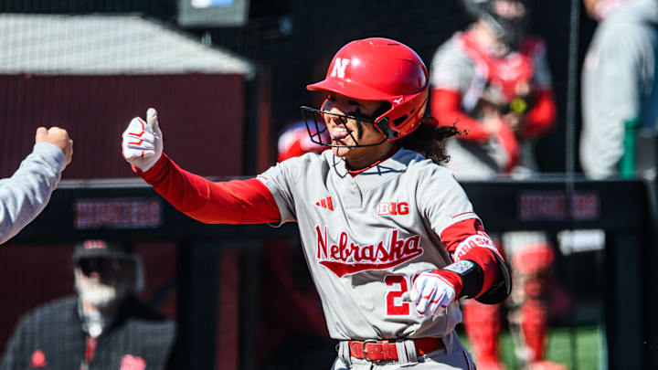 Bland rounds the bases to score on her home run. Bland rounds the bases to score on her home run.