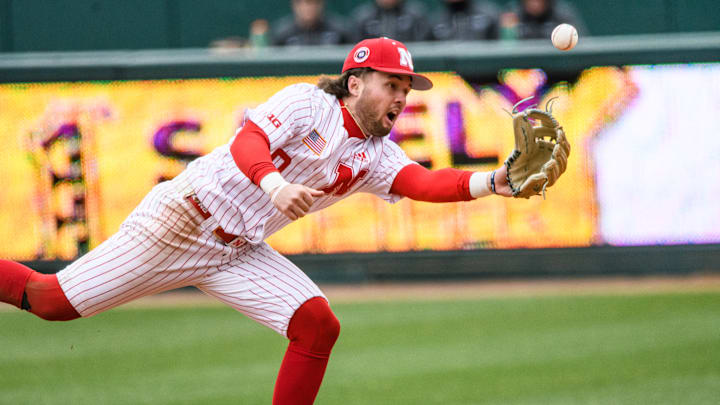 Cayden Brumbaugh attempts to toss the ball to first base, against Oregon State.