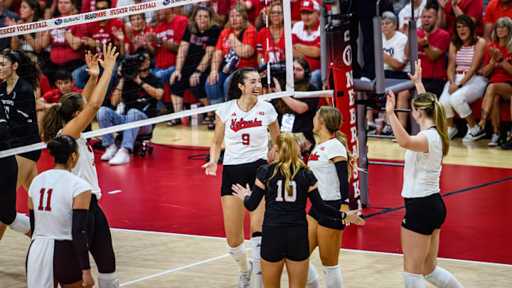 Virginia Adriano (9) celebrates with her teammates after a kill. 