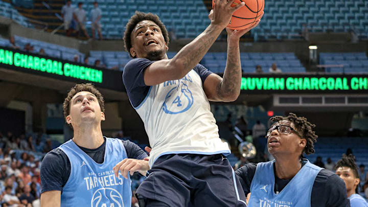 North Carolina guard Jaydon Young going up for a layup with Luka Bogavac and James Brown in the background at the Blue-White scrimmage.