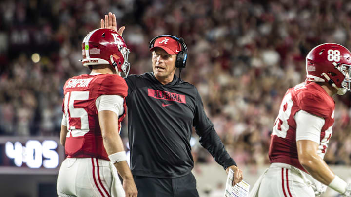 Alabama head coach Kalen DeBoer encourages quarterback Ty Simpson (15) as he runs off the field