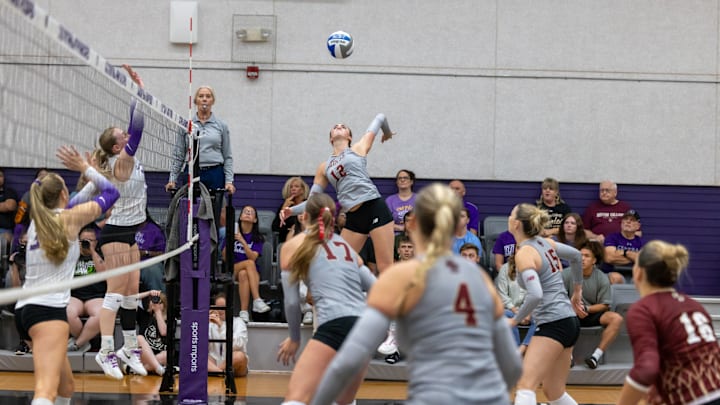 Boston College Volleyball junior Opposite Hitter Sam Hoppes jumps for a hit in earlier action.