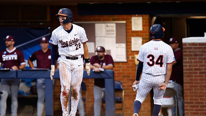 Jacob Ference and Harrison Didawick score runs during the Virginia baseball game against Mississippi State in the NCAA Tournament at Disharoon Park.