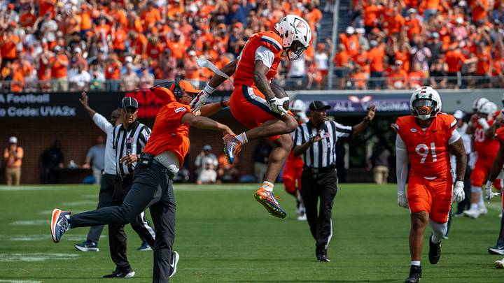 Tony Elliott and Brandyn Hillman celebrate a turnover forced by Virginia's defense.