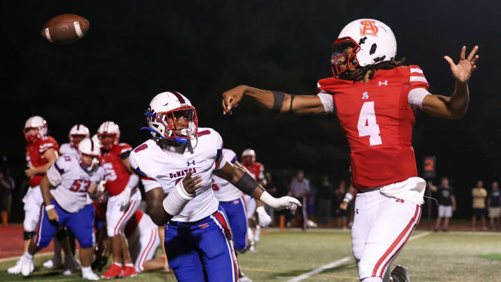 Archbishop Spalding quarterback Malik Washington follows through on a short touchdown toss, as DeMatha's Carey Darrell applies pressure. Spalding won the showdown between the Nos. 3 and 4 teams in last week's Maryland Top 25, 26-10. Archbishop Spalding quarterback Malik Washington follows through on a short touchdown toss, as DeMatha's Carey Darrell applies pressure. Spalding won the showdown between the Nos. 3 and 4 teams in last week's Maryland Top 25, 26-10.