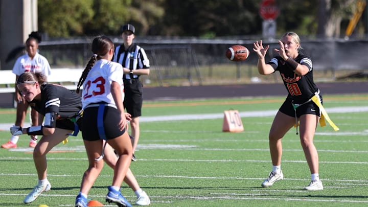 Oviedo quarterback Ansley Devos (10) prepares to take a snap during a game against Lake Mary in March, Last week, she completed 18 of 29 passes for 172 yards and one touchdown and rushed for 15 yards and two scores to lead the Lions past Lake Howell, 20-12, for the Class 3A, District 4 title.