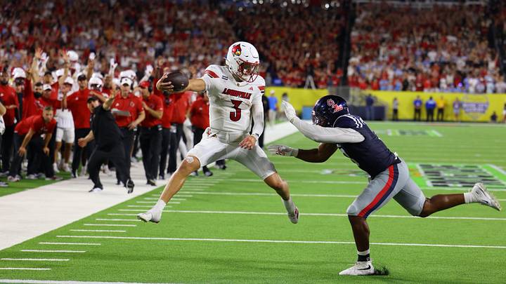 Lincoln Kienholz scrambles for a late touchdown to tie the game at 38, before the Rebels escaped on a game-winning field goal as time expired. 