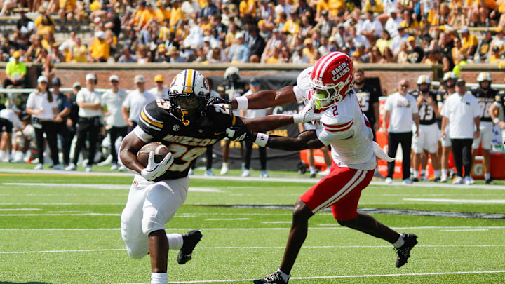 Sept. 13, 2025; Columbia, Missouri, USA; Missouri Tigers running back Ahmad Hardy pushes away from Louisiana Ragin' Cajuns' safety Jalen Clark on his way to the end zone.
