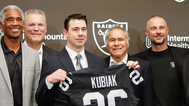 Coach Klint Kubiak and GM John Spytek flanked by multiple NFL, Raider greats.